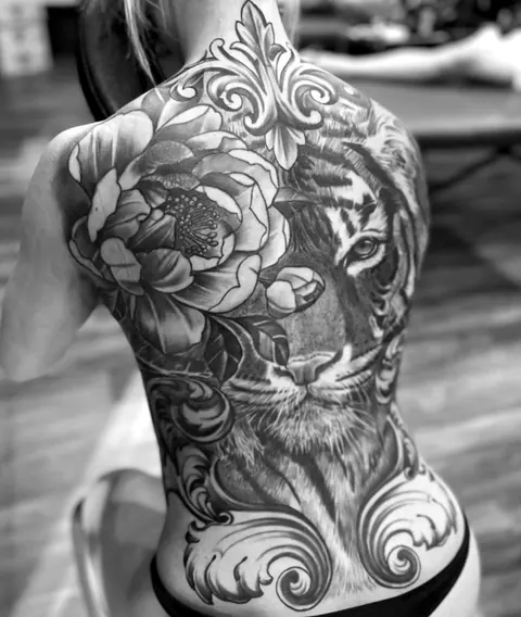 Black and grey tiger and peony back piece with ornamental filigree, tattooed at Mr Ink Bali in Seminyak